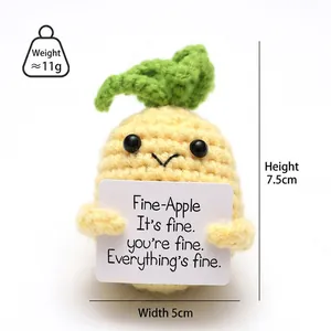 Macro shot of 7.5cm handmade crochet pineapple doll with positive message card