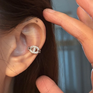 Chic silver pig nose ear cuff with micro-paved zircons worn on model's ear contour