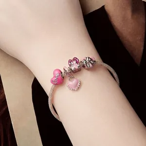 Pink heart charm mesh bracelet in 925 sterling silver worn on wrist with love charms