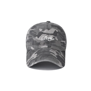 Close-up of white Dorle embroidery on vintage washed camouflage cotton baseball cap