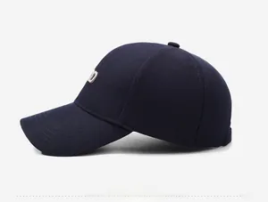 Detail view of navy blue baseball cap side profile with embroidered letter D