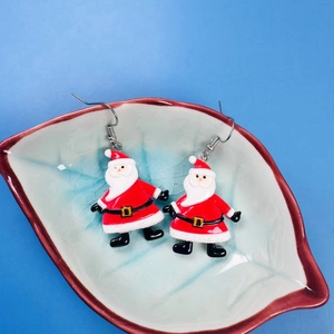 Cartoon Santa Claus acrylic drop earrings for Christmas party placed in a ceramic bowl