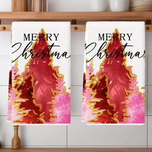 Detail of hanging kitchen towels with festive Christmas tree prints and gold glitter