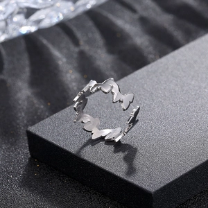 Detailed close-up of a silver butterfly open ring made of polished titanium steel