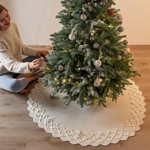 Knitted off-white Christmas tree skirt with festive woven patterns for holiday home decor