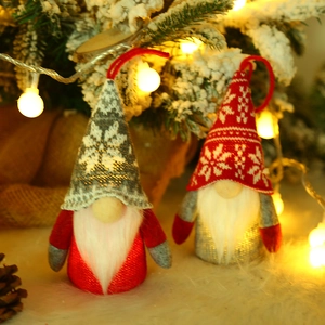 Lighted Christmas gnomes set with snowflake knit hats and warm festive background glow