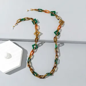 Macro shot of colorful acrylic eyeglass chain with geometric resin links and rubber loops