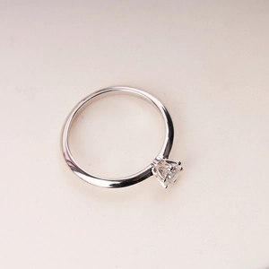 Macro shot of 1 carat moissanite gemstone with classic six-prong setting on silver ring