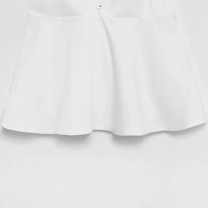 Front view of white backless V-neck sleeveless tank top showing fabric texture and S size tag