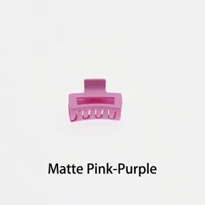 Macro detail of a 4cm matte pink-purple square hair claw clip with cutout design