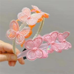 Detail of embroidered lace butterflies with sequins and beads on kids headbands