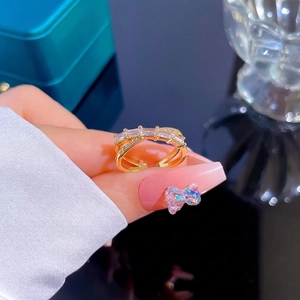 Gold plated crisscross open ring with emerald cut zircon and micro pave crystals