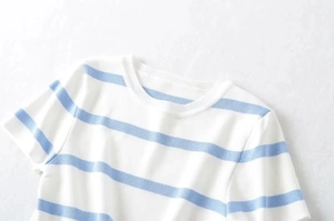 Detailed close-up of blue and white striped knit shirt showing fine fabric texture