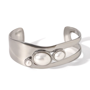Silver open bangle with three different sized white pearls and polished metal finish