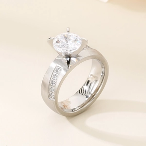 Detailed side view of silver four-prong diamond ring with side-stone channel setting