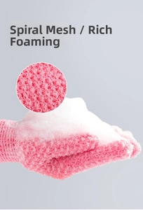 Detail of pink exfoliating bath mitt showing spiral mesh texture and rich foam lather