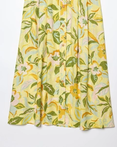 Detail view of linen blend floral skirt with bright yellow pattern and front button design