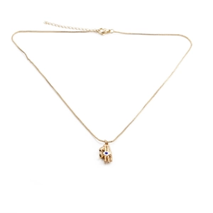 Detail of gold-plated palm pendant with Evil Eye inlay on a delicate box chain