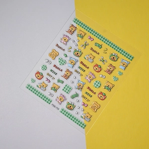 Detail of cute bear and koala nail stickers with green plaid patterns and heart motifs