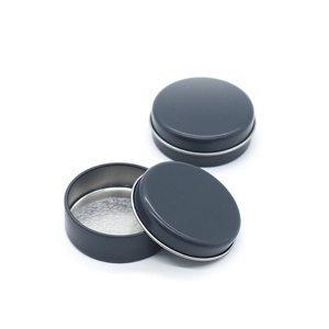 Macro view of matte black round metal tin showing open and closed storage structure
