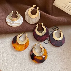 Chic acetate hoop earrings in marble and tortoiseshell patterns with gold ribbed metal