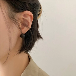 Minimalist black onyx stud earrings in 925 sterling silver worn by a model in Korean style
