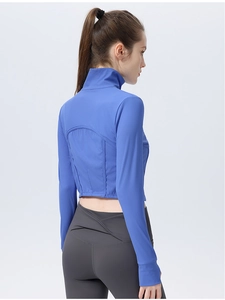 Detail of royal blue ribbed yoga jacket featuring back curved seams and thumbhole cuffs