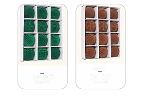 Close-up of green and brown flocked Christmas balls with embossed texture in a 12-pack box