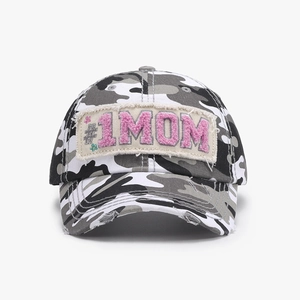 Detail of vintage camo baseball cap with frayed edges and pink #1 MOM plush patch