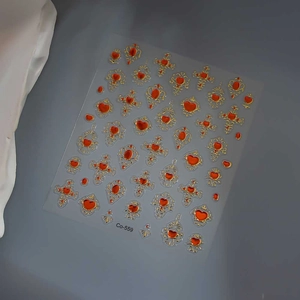 Detailed view of vintage gemstone nail stickers with red hearts and gold embossed frames