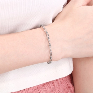 Bracelet minimaliste en acier inoxydable argenté à double maille porté par un mannequin