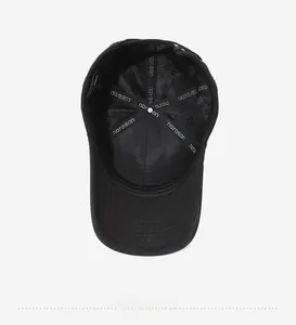 Detailed inside view of the black baseball cap showing breathable stitching and brand lining