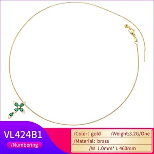Gold plated brass cross necklace with green pear gemstones and white zircon accents
