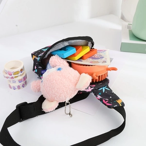 Detail showing the inner capacity of this kids' cartoon chest bag with various small toys