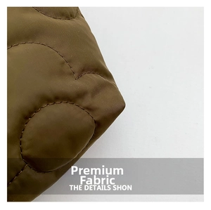 Macro shot of brown quilted fabric with wavy stitching and premium padding texture
