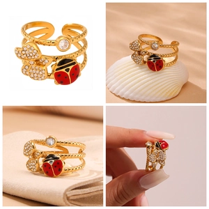 Detail of adjustable gold ring with ladybug, zircon butterflies and multi-layer band