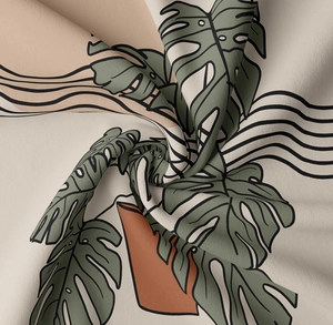 Detail shot of tropical monstera leaf print on soft bohemian tapestry fabric