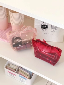 Mesh makeup bag with ruffled edges and heart embroidery in pink and burgundy colors