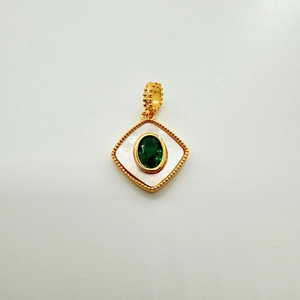 Macro view of a 18K gold plated square pendant with green gemstone and natural white shell