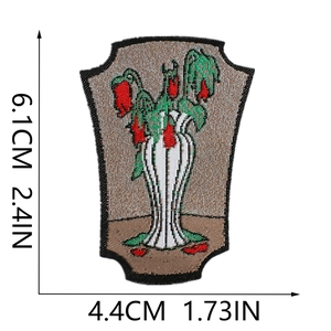 Close-up of embroidered plant patch with dimensions 6.1cm by 4.4cm on white background