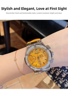 Vue détaillée de la montre à quartz Dinimi pour femme avec cadran orange et strass.