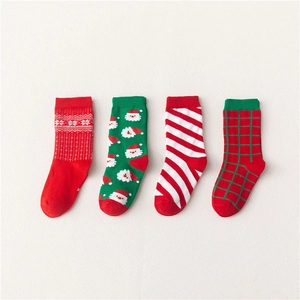 Set of 4 festive Christmas cotton socks for children featuring Santa and snowflake patterns