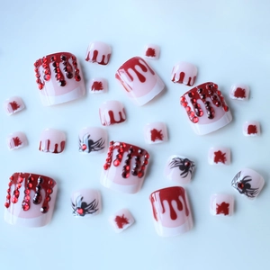 Halloween toe press-on nails with dark blood drips, red rhinestones, and black spider patterns