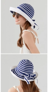 Detail of blue and white striped sun hat featuring a delicate bow on the back