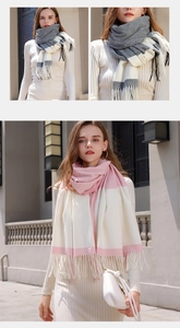 Detail view of pink and gray checkered tassels on a soft cashmere-feel scarf