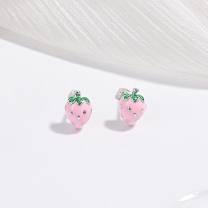 Detail of pink strawberry stud earrings in S925 silver with green enamel leaf accents