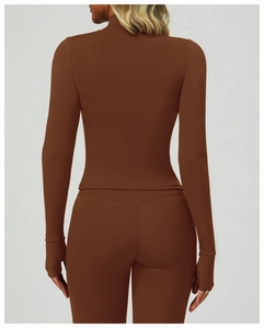 Detail of coffee brown yoga top featuring thumbhole cuffs and high-elastic athletic fabric