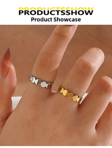 Detailed view of wave-edge geometric rings in polished gold and silver finishes