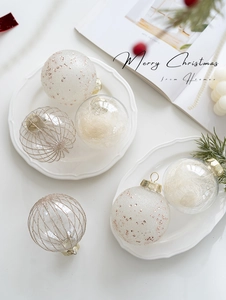 Detailed view of luxury gold and white Christmas balls with glitter and silk fillings