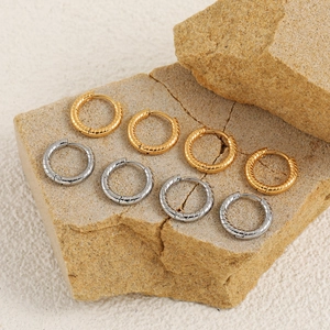 Minimalist twisted rope hoop earrings in gold and silver finish on stones